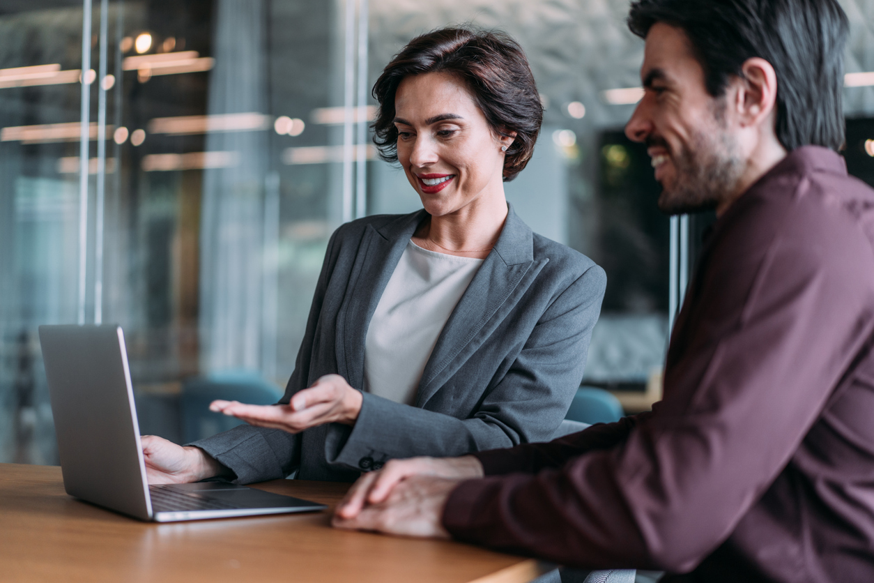 Investment Performance: Female financial advisor reassures client during meeting.